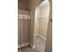 Bathroom shower with neutral shower curtain with ocean themed decorations and a walk-in closet with built in shelving at 10869 Spirit Dr, Ingalls, IN 46048
