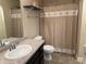 Cozy bathroom with light walls, neutral countertops, and a shower featuring a decorative ocean themed curtain at 10869 Spirit Dr, Ingalls, IN 46048