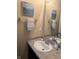 Bathroom vanity with neutral countertops and dark cabinets, wall art, and towel rack, creating a welcoming space at 10869 Spirit Dr, Ingalls, IN 46048