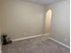 Bedroom with neutral walls, carpet, minimalist decor and an arched doorway leading to an additional room or closet at 10869 Spirit Dr, Ingalls, IN 46048