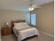 Bright bedroom with a ceiling fan, plush carpeting, and a comfortable queen-sized bed at 10869 Spirit Dr, Ingalls, IN 46048