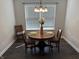 Dining room featuring an elegant chandelier, round table, and natural light at 10869 Spirit Dr, Ingalls, IN 46048