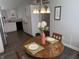 Dining area with a wooden table, chandelier, and a view to the kitchen at 10869 Spirit Dr, Ingalls, IN 46048