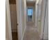 Hallway showing access to bathroom and bedroom with carpeted floor at 10869 Spirit Dr, Ingalls, IN 46048
