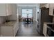 Bright kitchen and dining area with modern appliances and dark hardwood floors at 10869 Spirit Dr, Ingalls, IN 46048