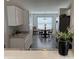 Bright kitchen showcasing white cabinets and a view of the dining area at 10869 Spirit Dr, Ingalls, IN 46048