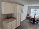 Open kitchen with white cabinets, granite countertops, and dining area at 10869 Spirit Dr, Ingalls, IN 46048