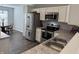 Stainless steel appliances, granite countertops, and a double sink highlight this modern kitchen at 10869 Spirit Dr, Ingalls, IN 46048