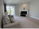 Inviting living room with a fireplace, neutral tones, and sliding glass doors to the outdoor space at 10869 Spirit Dr, Ingalls, IN 46048