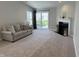 Spacious living room featuring plush carpet, a fireplace, and sliding glass doors to the backyard at 10869 Spirit Dr, Ingalls, IN 46048