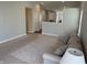 Open-concept living room with neutral paint, plush carpeting, and access to kitchen at 10869 Spirit Dr, Ingalls, IN 46048