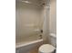 Bright bathroom featuring a white shower-tub combo with shower curtain, and standard toilet at 10949 Harness Way, Indianapolis, IN 46239