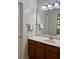 Well-lit bathroom with a vanity, sink, mirror, and towel racks at 10949 Harness Way, Indianapolis, IN 46239