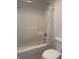 This is a bathroom with a standard bathtub with shower and a white toilet at 10949 Harness Way, Indianapolis, IN 46239