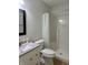 Updated bathroom featuring a sleek vanity, toilet, and walk-in shower with sliding shower curtain at 10949 Harness Way, Indianapolis, IN 46239