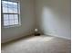 Carpeted bedroom featuring a window to the outside, neutral walls, and a small lamp at 10949 Harness Way, Indianapolis, IN 46239