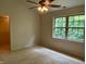 Bedroom featuring a large window view, a ceiling fan, and access to a walk-in closet at 10949 Harness Way, Indianapolis, IN 46239
