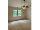 Spacious bedroom featuring a ceiling fan and a large window that offers a green, wooded view at 10949 Harness Way, Indianapolis, IN 46239