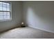 This cozy bedroom features neutral carpeting and a window offering natural light at 10949 Harness Way, Indianapolis, IN 46239