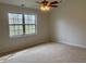 Inviting bedroom features a large window overlooking an outside area at 10949 Harness Way, Indianapolis, IN 46239