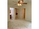 Large bedroom with multiple doorways and neutral carpet leading to bathroom and walk-in closet at 10949 Harness Way, Indianapolis, IN 46239