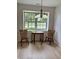 Charming dining area featuring a table and chairs set by a bright window offering a pleasant view at 10949 Harness Way, Indianapolis, IN 46239
