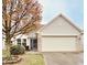 Charming single-Gathering home featuring a two-car garage, brick accents, and mature landscaping at 10949 Harness Way, Indianapolis, IN 46239