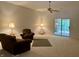 Bright living room featuring neutral carpet, ceiling fan, and sliding glass door to the exterior at 10949 Harness Way, Indianapolis, IN 46239