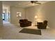 Spacious living room features neutral carpeting, a ceiling fan, and access to other parts of the home at 10949 Harness Way, Indianapolis, IN 46239