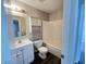 Bathroom features a white vanity, toilet, tub, and shower with storage at 11147 Autumn Creek Ct, Indianapolis, IN 46229