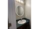 Bathroom with green countertop and round mirror at 11147 Autumn Creek Ct, Indianapolis, IN 46229
