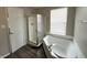 Full bathroom with shower, tub, and modern wood-look laminate flooring at 11147 Autumn Creek Ct, Indianapolis, IN 46229