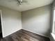 Cozy bedroom featuring neutral walls, modern ceiling fan, and wood-look laminate flooring at 11147 Autumn Creek Ct, Indianapolis, IN 46229