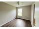 Bedroom with wood-look floors and a large window at 11147 Autumn Creek Ct, Indianapolis, IN 46229