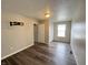 Bedroom featuring wood-look floors, a wall-mounted tv bracket, and a closet at 11147 Autumn Creek Ct, Indianapolis, IN 46229