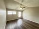 Bright bedroom with vaulted ceiling, natural light from windows, and wood-look laminate flooring at 11147 Autumn Creek Ct, Indianapolis, IN 46229
