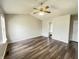 Spacious bedroom boasts an ensuite bathroom, wood-look laminate flooring, and neutral walls at 11147 Autumn Creek Ct, Indianapolis, IN 46229