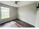 Bedroom with wood-look floors, a window, and ceiling fan at 11147 Autumn Creek Ct, Indianapolis, IN 46229