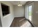 Dining area with wood floors, sliding glass doors, and a view of the kitchen at 11147 Autumn Creek Ct, Indianapolis, IN 46229