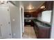 View of a kitchen with dark cabinets, stainless steel appliances, and a tiled floor at 11147 Autumn Creek Ct, Indianapolis, IN 46229