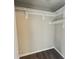 Walk-in closet offers ample storage space with shelves and wood-look laminate flooring at 11147 Autumn Creek Ct, Indianapolis, IN 46229