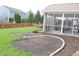 Backyard featuring a screened-in porch, garden bed, and trampoline at 11149 Titania Ct, Noblesville, IN 46060
