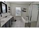 Bright bathroom with double sinks, shower, tub, and contemporary finishes at 11149 Titania Ct, Noblesville, IN 46060