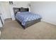 Neutrally decorated bedroom featuring carpet floors and a bed frame with built-in storage at 11149 Titania Ct, Noblesville, IN 46060