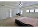 Spacious primary bedroom featuring a ceiling fan, a connecting bathroom, and a workstation at 11149 Titania Ct, Noblesville, IN 46060