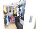Organized walk-in closet with clothing racks, shelves and suitcase storage at 11149 Titania Ct, Noblesville, IN 46060