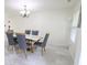 Bright dining area boasts modern decor, marble floors, and a chandelier over a table for six at 11149 Titania Ct, Noblesville, IN 46060