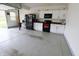 Garage with white cabinets, black appliances, and a speckled floor at 11149 Titania Ct, Noblesville, IN 46060