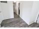Hallway with wood floors and white walls, offering a clean and open transition between rooms at 11149 Titania Ct, Noblesville, IN 46060