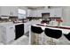 Modern kitchen featuring white cabinets, a breakfast bar with chairs, and stainless steel appliances at 11149 Titania Ct, Noblesville, IN 46060